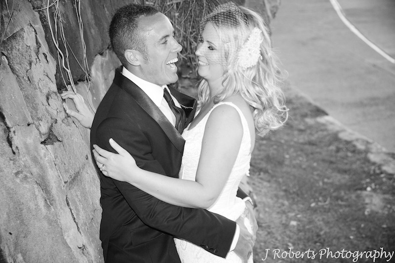 Groom laughing while he grabs brides bottom - wedding photography sydney